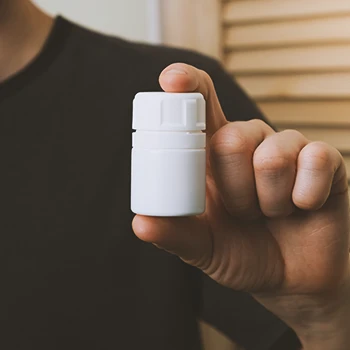 A person holding yohimbine supplements