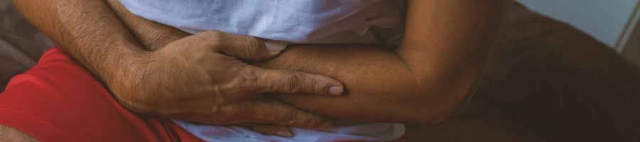 A person holding his stomach due to pain