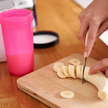 A woman cutting bananas