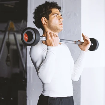 A man in the gym lifting weights