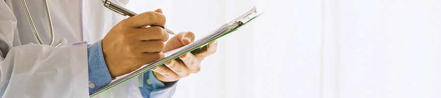 A doctor looking at a clipboard