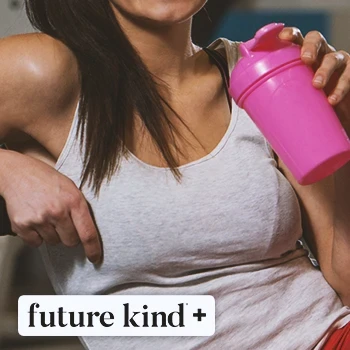 A person drinking from a tumbler in the gym with the Future Kind logo in the foreground