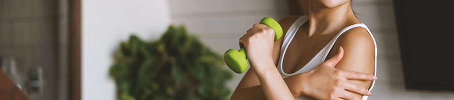 A person lifting light weights at home