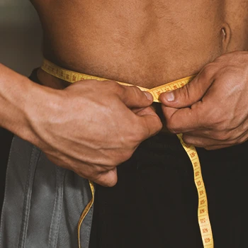 A man measuring his belly muscle fat