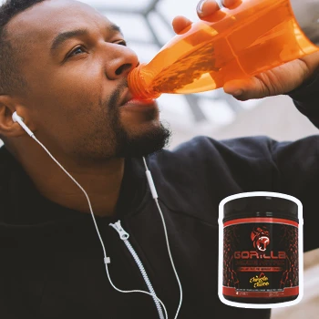 A person drinking from a tumbler with Gorilla Mode Nitric in the foreground