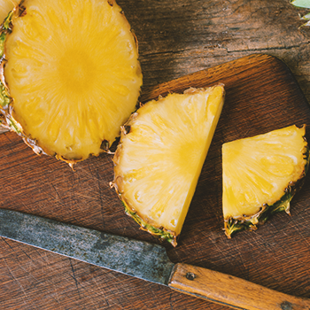 Sliced pineapples on a chopping board