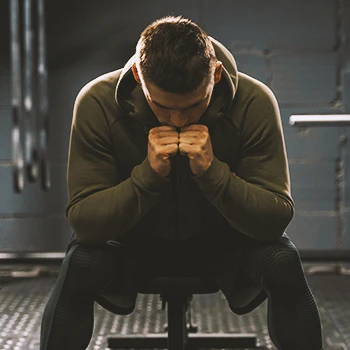 A buff male shivering in the gym