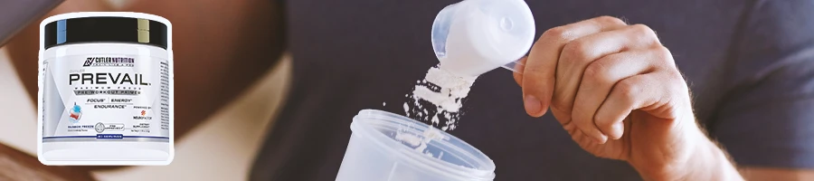 Close up shot of someone pouring pre-workout with Prevail pre-workout in the foreground