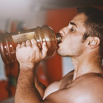A buff male drinking pre-workout
