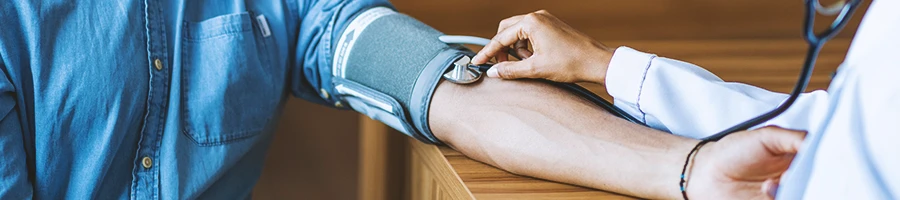 A doctor checking a patient's blood pressure