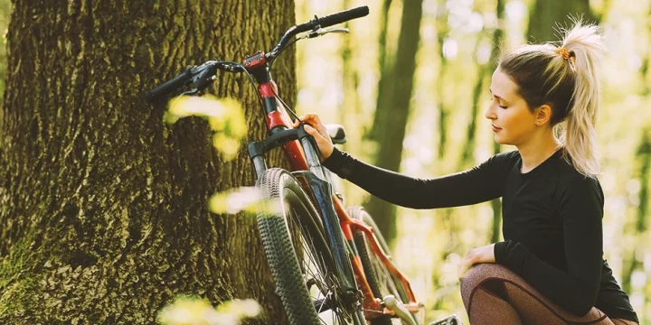 A hot female mountain bike rider in the forest