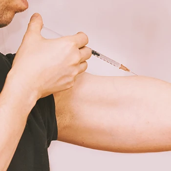 A person injecting steroids