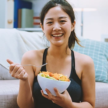 A fit person at home eating healthy food