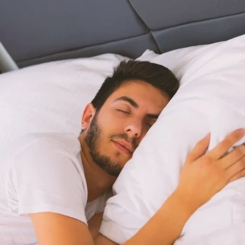 A man having a good sleep on his bed