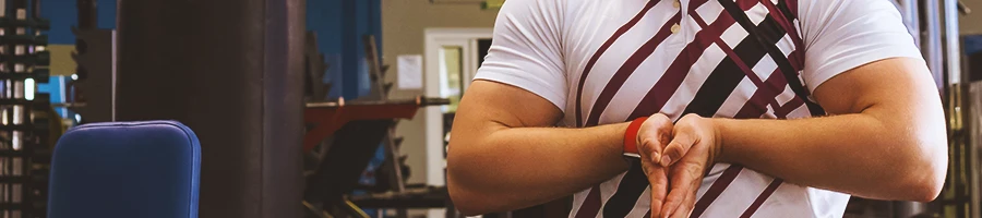 A man in the gym flexing his muscles