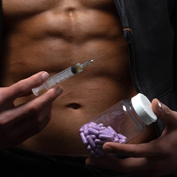 A man holding anabolic steroid shot and supplement pills