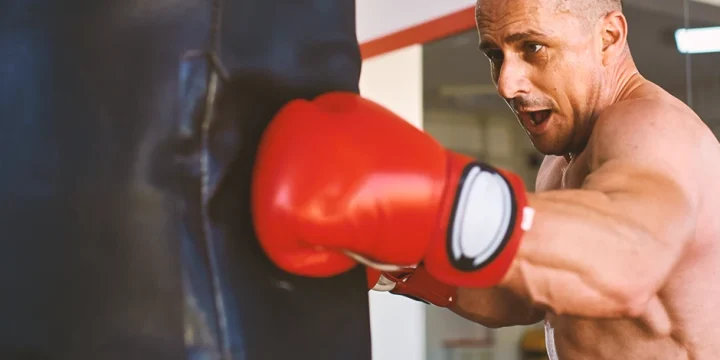 A boxer punching a punching bag