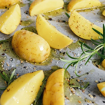 Baked potatoes on top of an oven tray