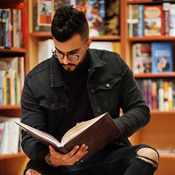 A man focused reading in a library