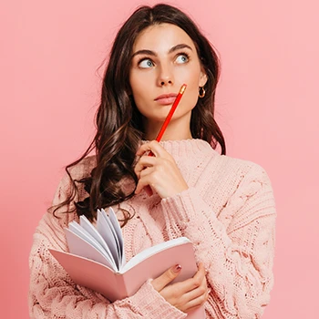 A woman thinking while holding book