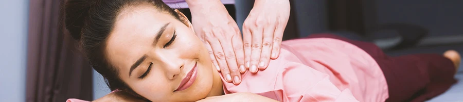 A woman smiling while getting massaged