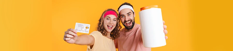 A couple holding bank card and a supplement container