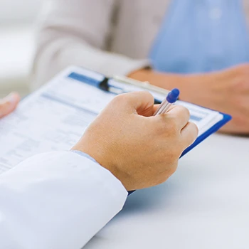 A doctor looking at a clipboard