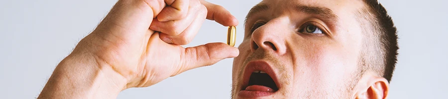 A person intaking vitamin E pills for testosterone