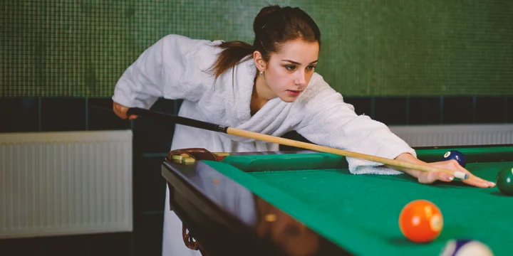 A beautiful woman playing pool