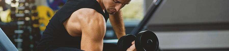 A man lifting a dumbbell in the gym