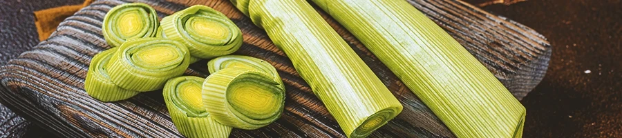 Leek soup chopped up on a wooden board