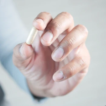 Holding a capsule in front of the camera