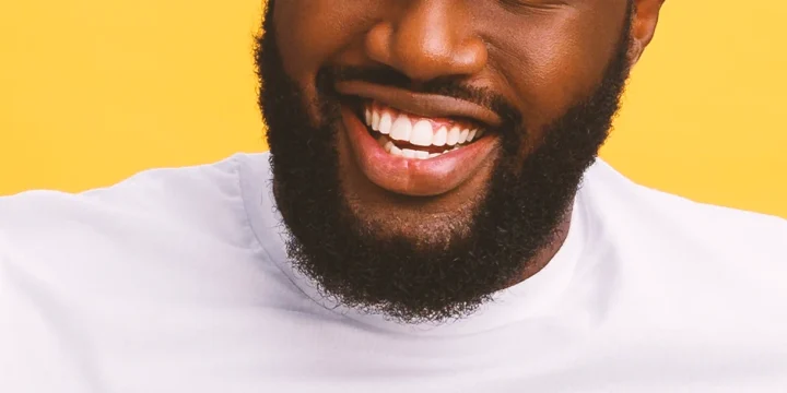 A bearded man smiling at the camera