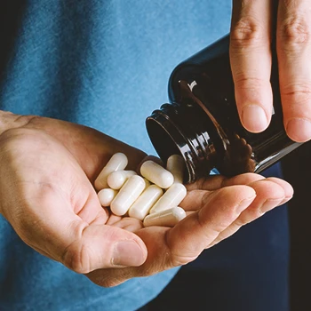 A person holding a bunch of pills