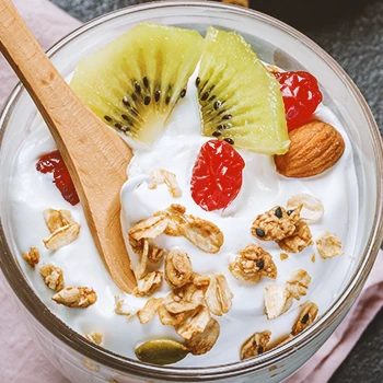 Close up shot of greek yogurt with fruits, nuts and seeds