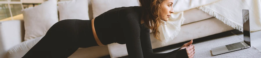 A woman doing planks at home