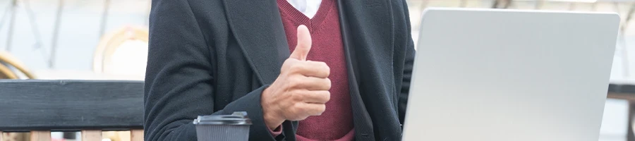 Giving thumbs up while using laptop