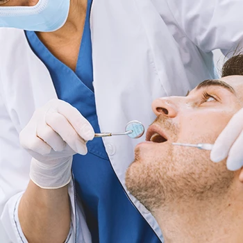 A dentist looking at a patient's teeth