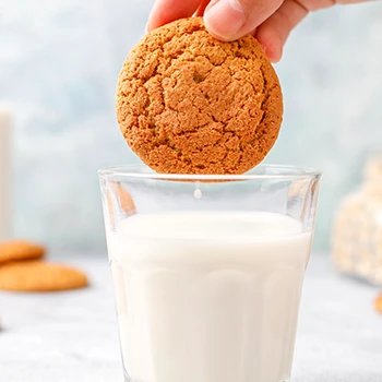 Protein cookie being dipped in oatmilk