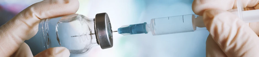 Close up shot of a steroid bottle and syringe
