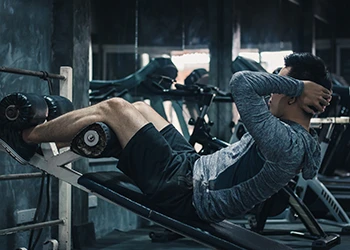 A man doing inclined sit ups