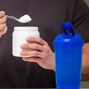 A man holding a supplement powder container