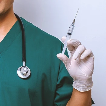 Close up shot of a doctor holding a syringe