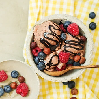 Ice cream with mixed fruits inside a bowl