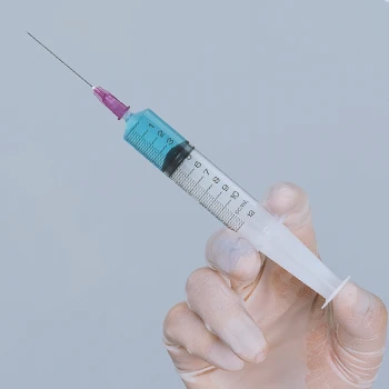 Close up shot of a person holding a syringe