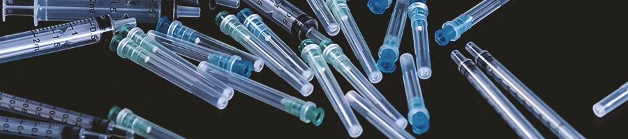 A stack of syringes on a black cloth