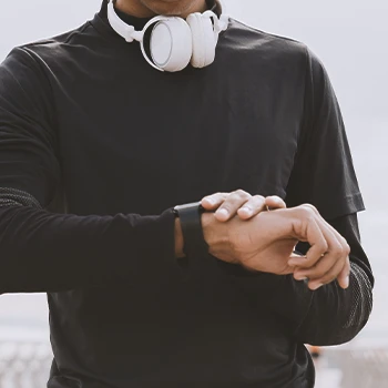 Close up shot of a jogger looking at his watch