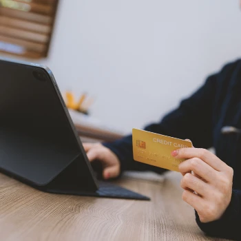 A person shopping online with a credit card