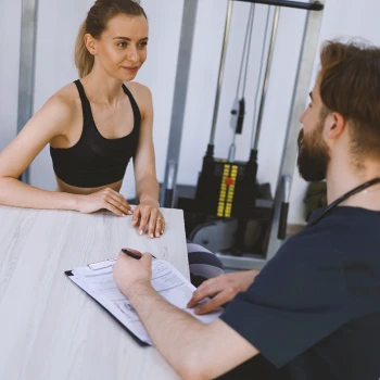 A doctor talking to a gym goer