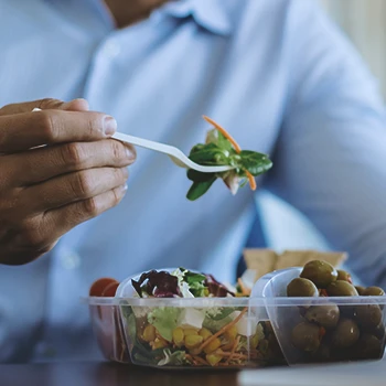 Close up shot of someone eating a salad